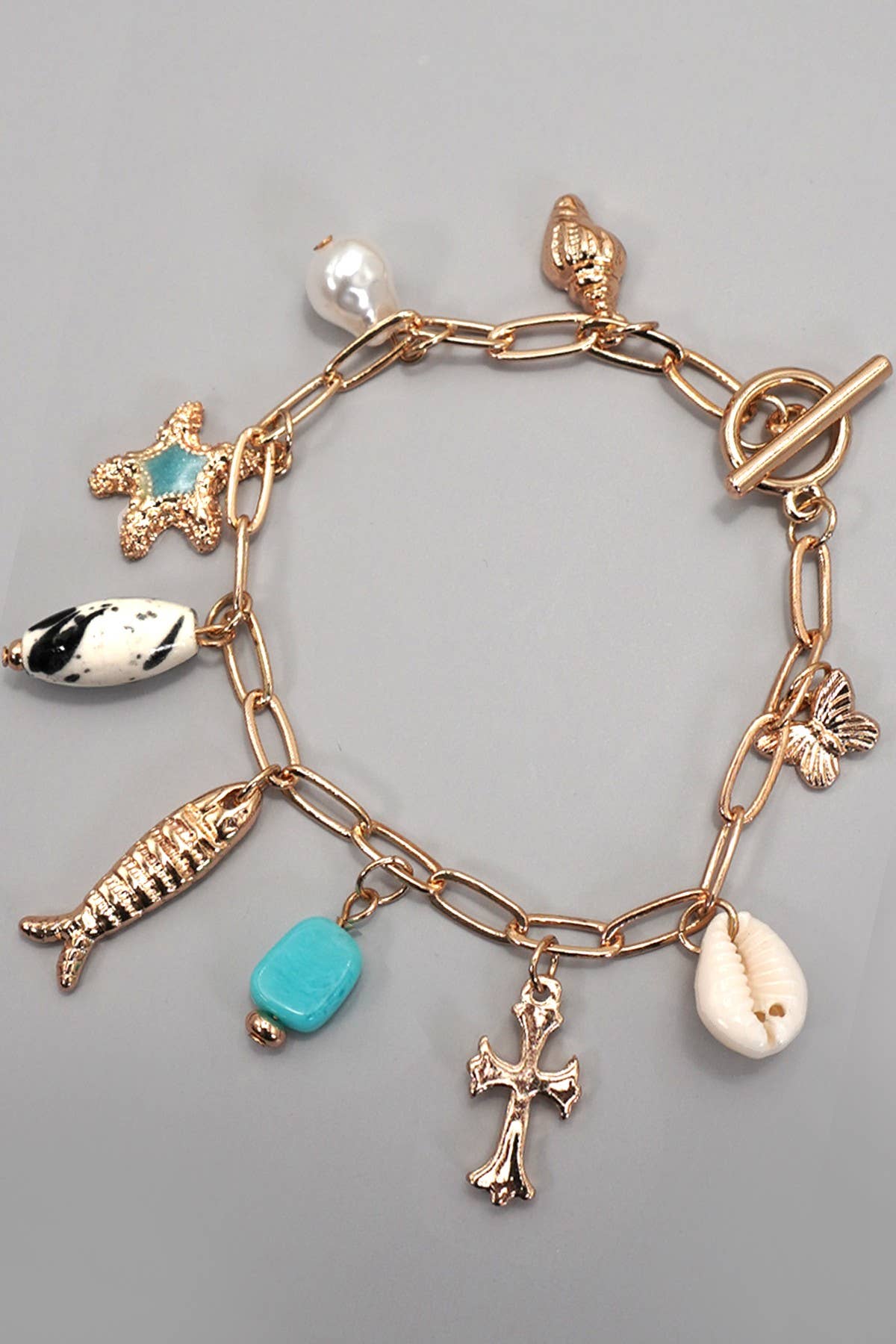 CHARM TOGGLE BRACELET-FISH CROSS CONCH PEARL | GOLD